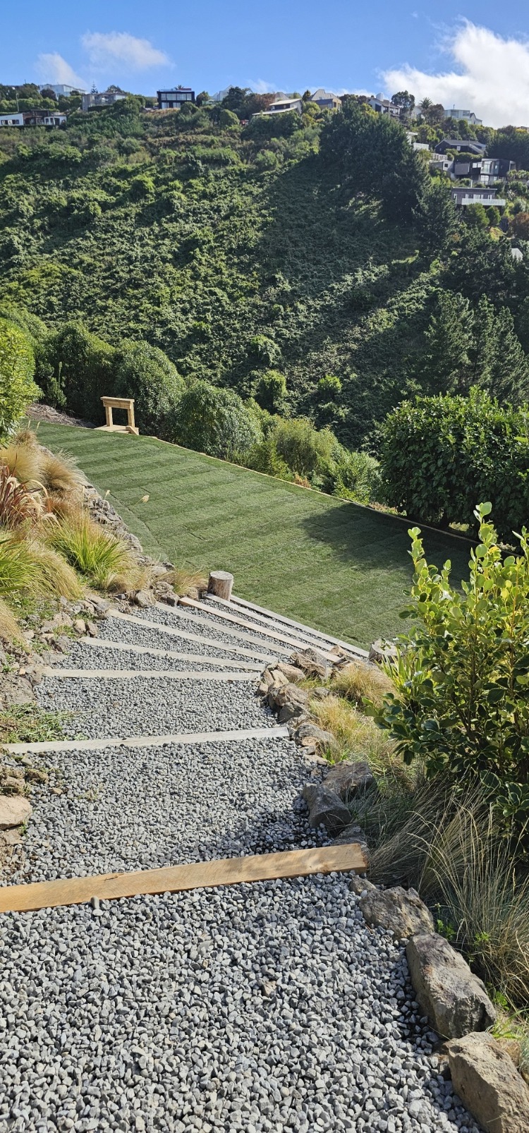 Gravel garden steps descending through a planted hillside